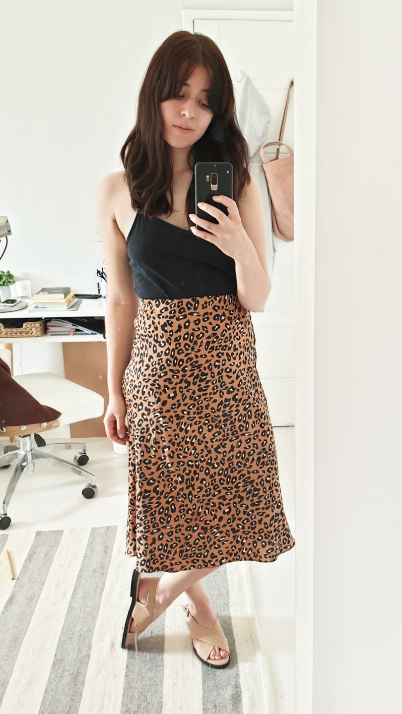 Black strappy top with leopard print skirt and nude sandals