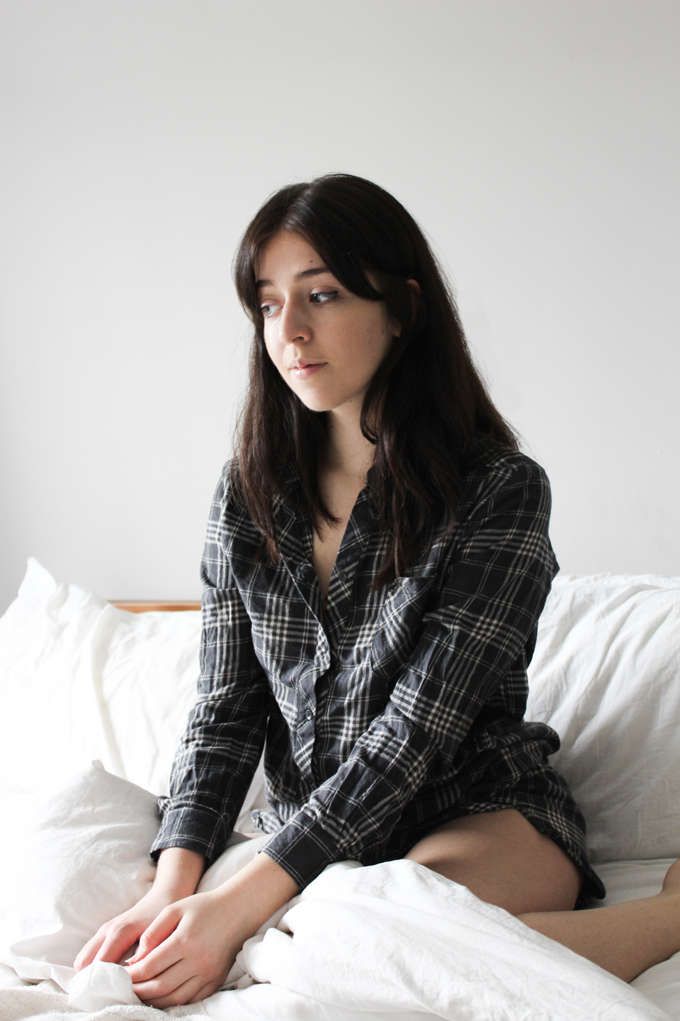 Besma wears a grey check nightie from Thought Clothing