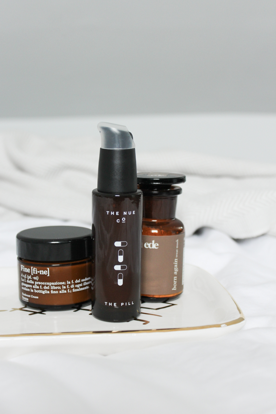 Three skincare products in brown bottles
