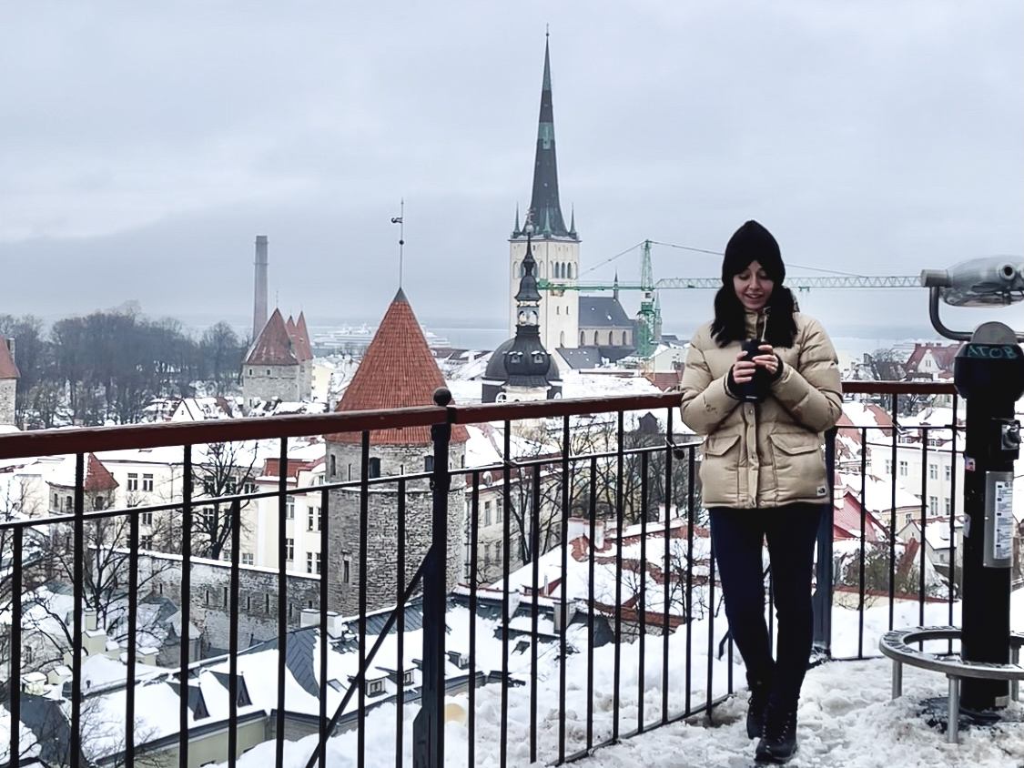 Besma standing in winter clothing with Tallinn in background