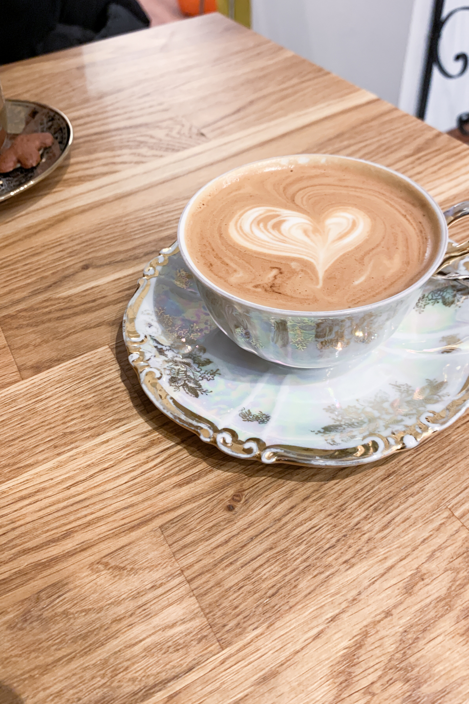 Flat white with heart-shaped coffee art at Crumble Cake café