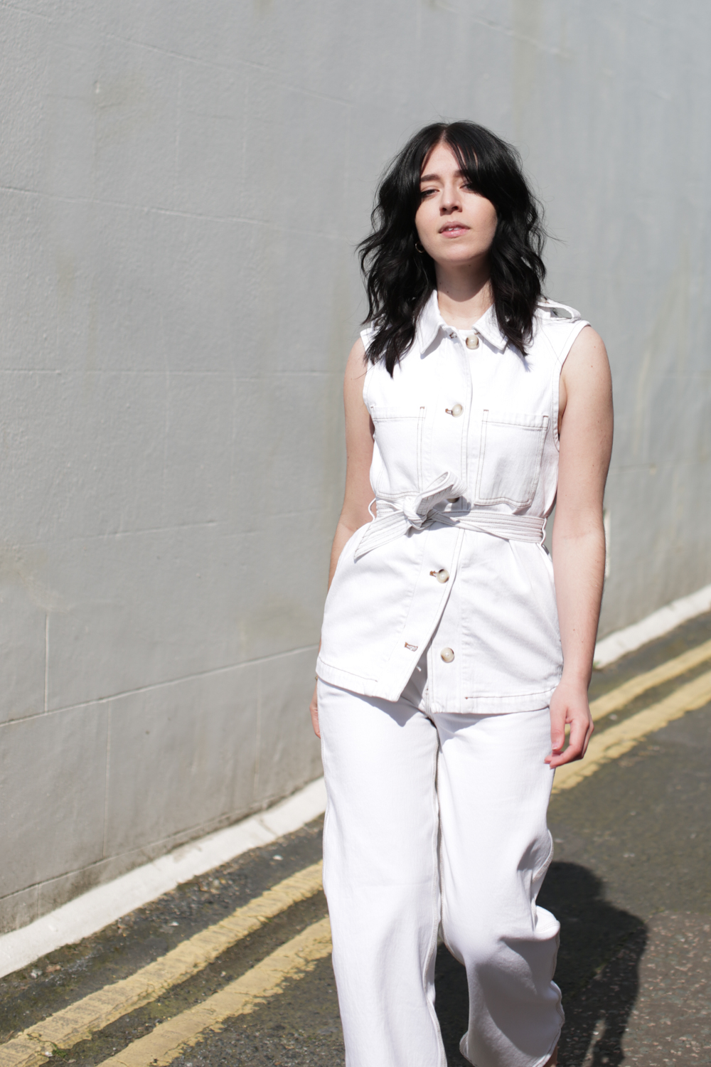 Besma wears all white denim outfit from Seventy + Mochi
