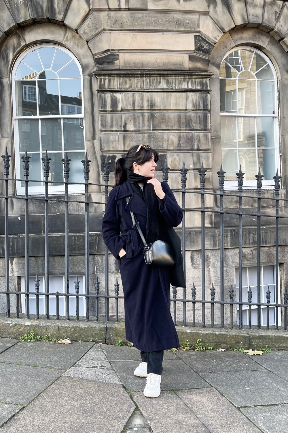 Besma standing in winter coat in Edinburgh