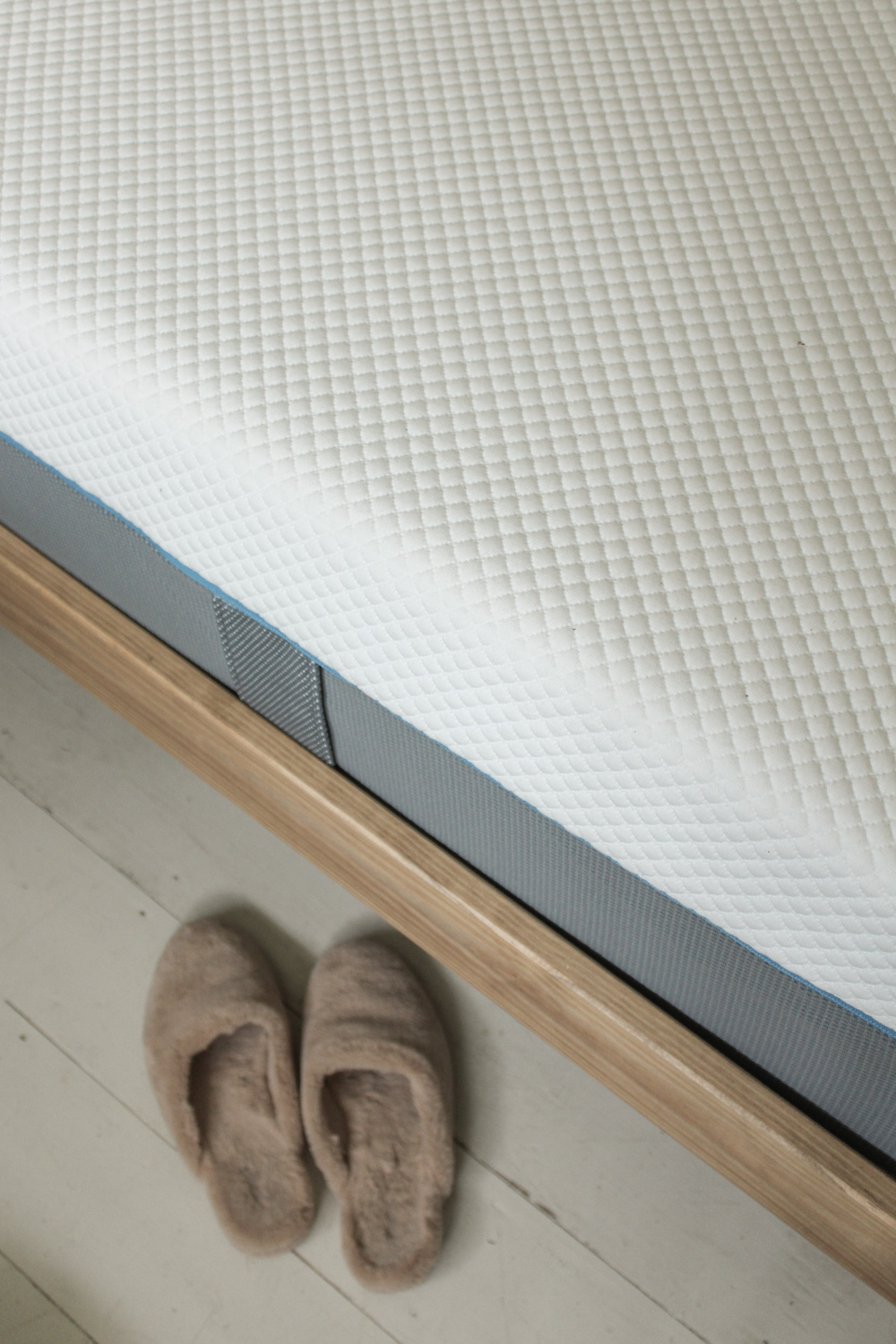 Slippers next to memory foam mattress