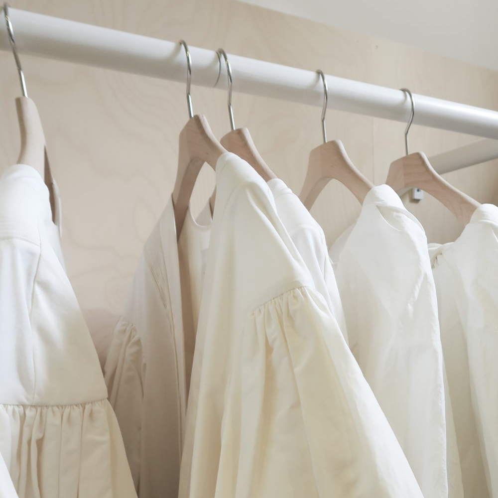 White dresses hanging on a rack