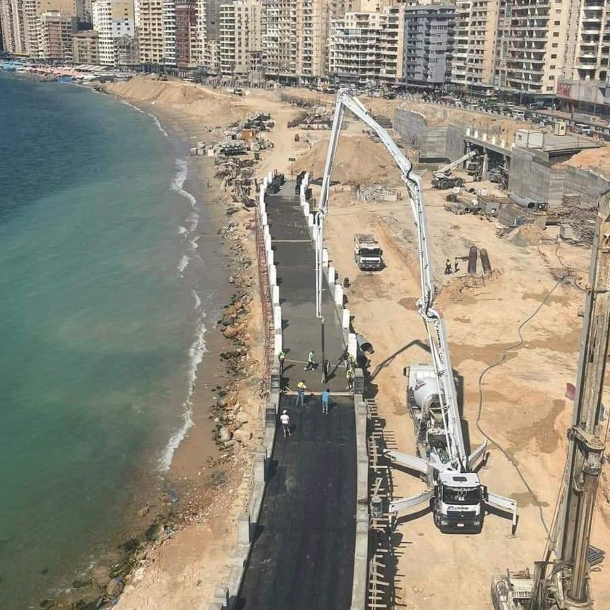 Construction taking place on road next to beach in Alexandria, Egypt