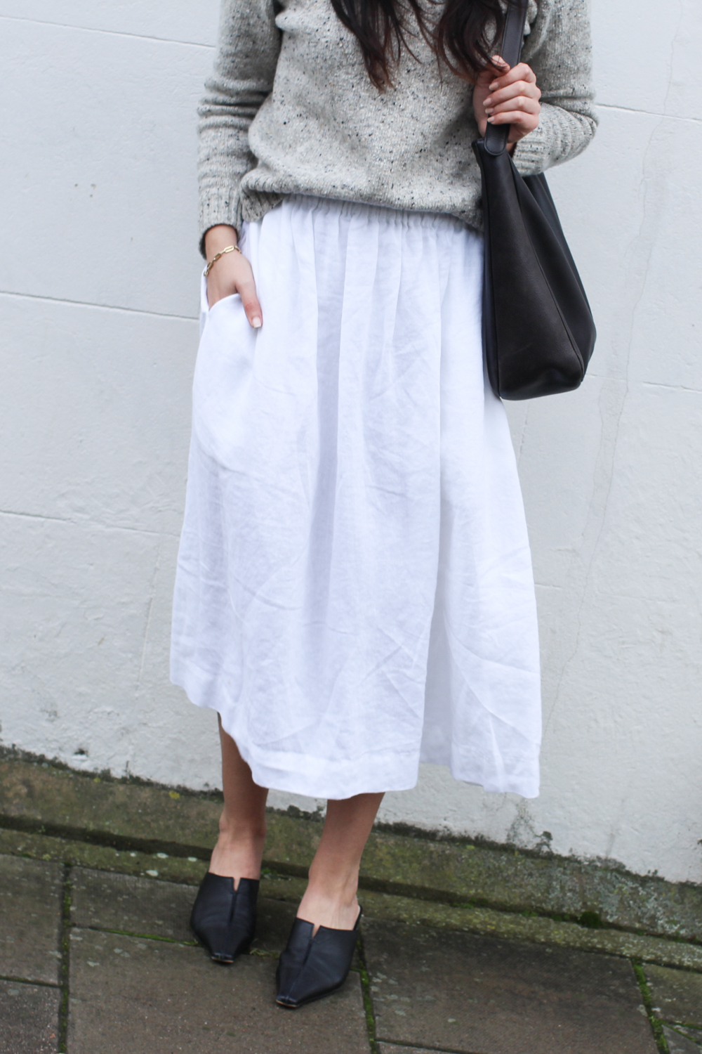 Close-up of white linen skirt outfit