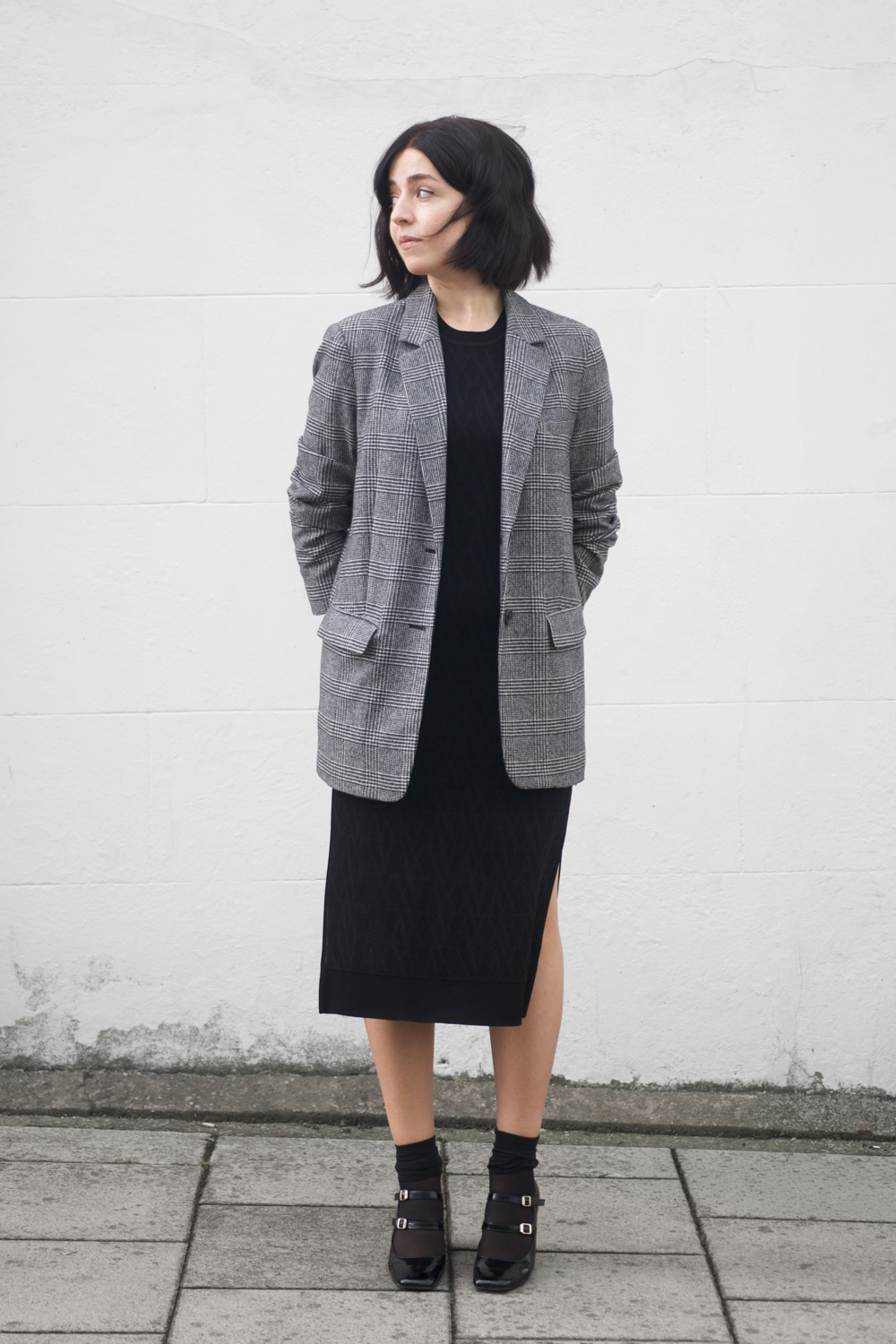 Besma wears black shift dress styled for Autumn outfit