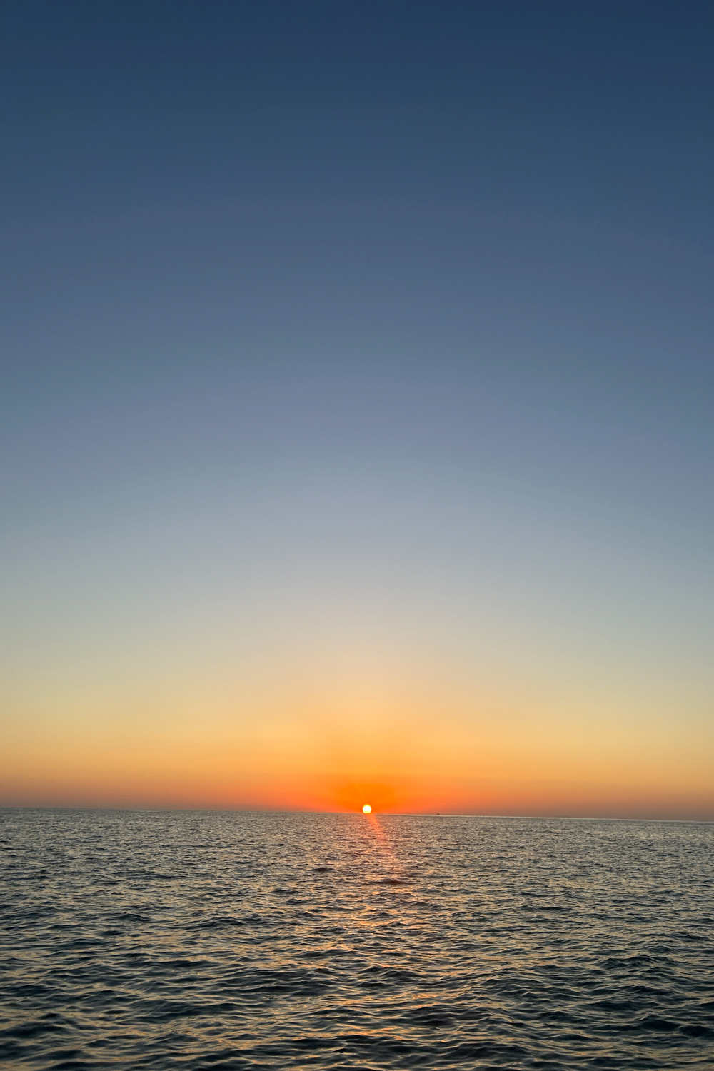 Sunset seen from sea on Milos island