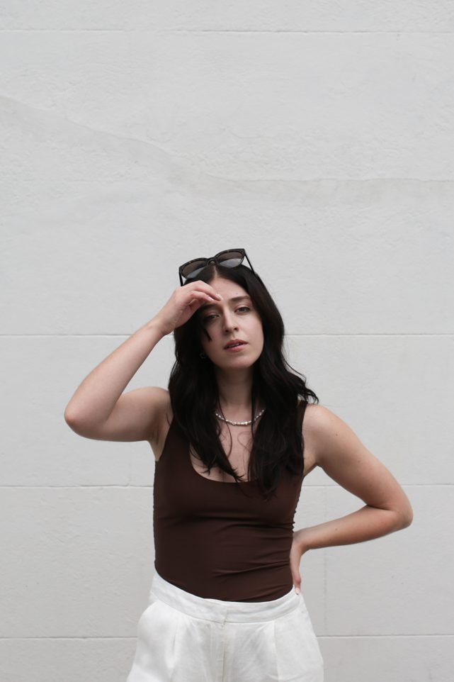 Close-up of Besma looking at camera wearing sunglasses on head