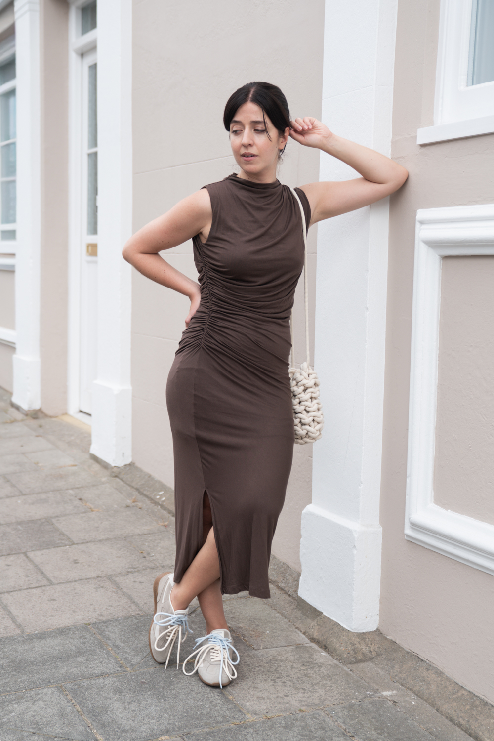 Besma wears SAYE sneakers with brown dress and lace bag