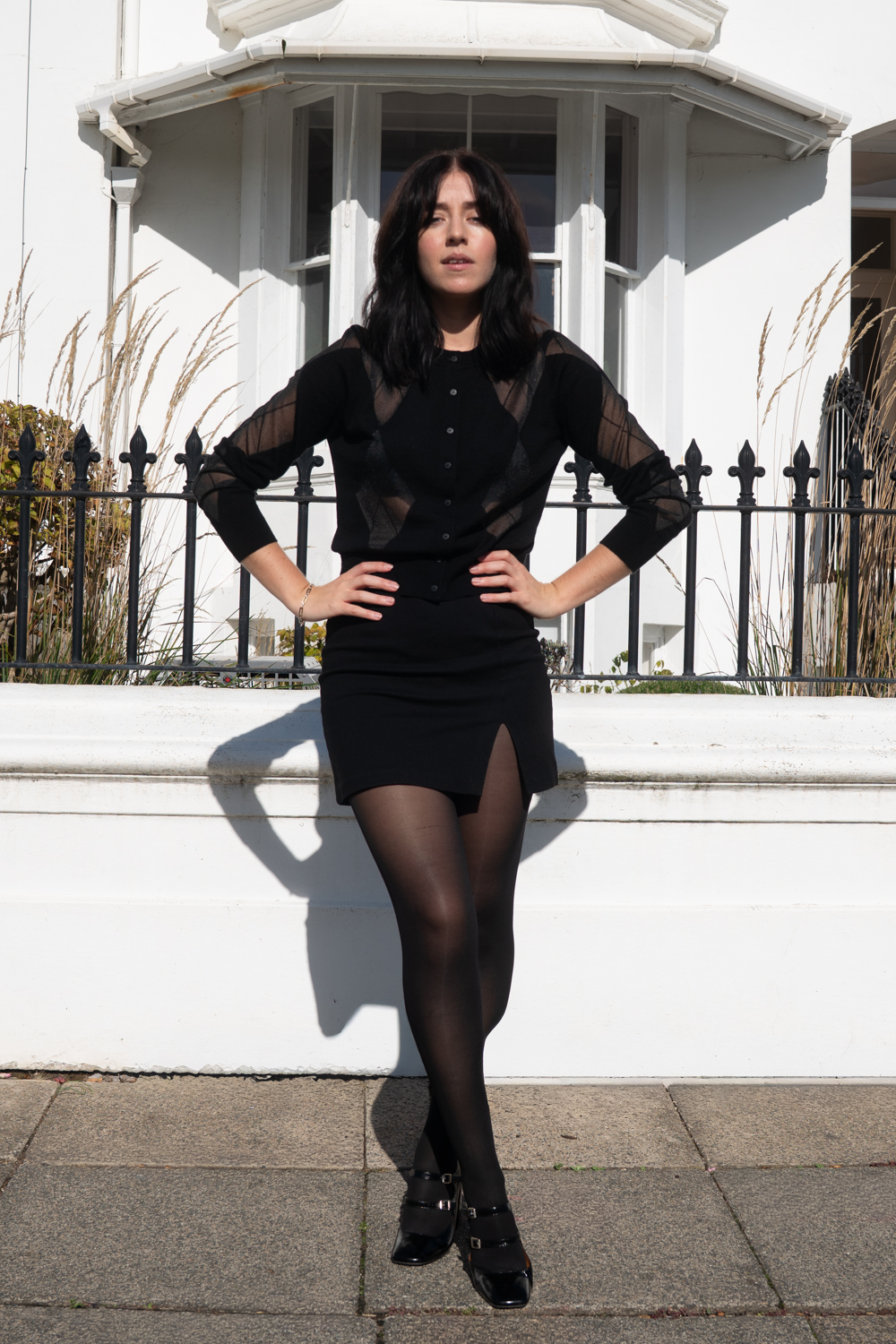 Black sheer top with skirt and tights outfit